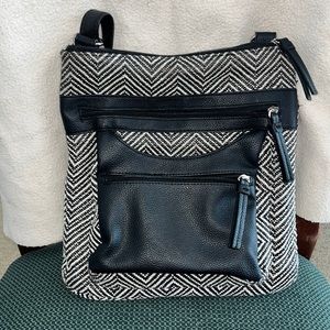 Black and white purse with two front zipper pockets.